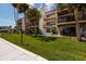 Exterior view of a condo building with balconies overlooking manicured lawn and mature palm trees at 222 Skiff Pt, Clearwater, FL 33767