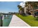 Exterior of condo building with dock and green lawn for scenic waterfront living at 222 Skiff Pt, Clearwater, FL 33767