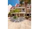 Charming townhome featuring a two-car garage and a cozy entrance framed by lush tropical landscaping at 222 Skiff Pt, Clearwater, FL 33767
