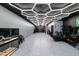 Large garage with storage cabinets, a vehicle simulator, and customized epoxy flooring at 222 Skiff Pt, Clearwater, FL 33767