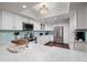 Bright kitchen with white cabinets, stainless steel appliances, and a lovely blue tile backsplash at 222 Skiff Pt, Clearwater, FL 33767