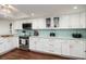 Well-lit kitchen featuring white cabinetry, stainless steel appliances, and a beautiful backsplash at 222 Skiff Pt, Clearwater, FL 33767
