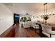 Open-concept living and dining area with modern lighting, wood floors, and a cozy fireplace at 222 Skiff Pt, Clearwater, FL 33767