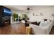 Inviting living room with fireplace, wood floors, and access to a balcony overlooking the water at 222 Skiff Pt, Clearwater, FL 33767