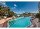 Inviting pool with blue water, brick patio, chairs, and bay views in a tropical setting at 222 Skiff Pt, Clearwater, FL 33767