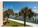 Stunning water views featuring a private boat dock, waterfront access, and tropical landscaping at 222 Skiff Pt, Clearwater, FL 33767