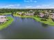 Aerial view showcasing a community with pristine lakes, a lush golf course, and beautifully landscaped homes at 2490 Kensington Greens Dr # 0, Sun City Center, FL 33573