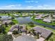 An aerial view of a luxurious lakeside community, boasting well-manicured lawns and tranquil water views at 2490 Kensington Greens Dr # 0, Sun City Center, FL 33573