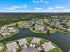 Aerial view of a beautiful community with lush green lawns, winding lakes, and meticulously maintained landscaping at 2490 Kensington Greens Dr # 0, Sun City Center, FL 33573