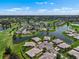 Panoramic aerial view of a community featuring lakes, a golf course, and meticulously landscaped residential areas at 2490 Kensington Greens Dr # 0, Sun City Center, FL 33573