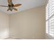 Neutral toned bedroom with ceiling fan and plantation shutters on the windows at 2490 Kensington Greens Dr # 0, Sun City Center, FL 33573