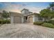 Elegant home featuring a paver driveway and a grand two-car garage at 2490 Kensington Greens Dr # 0, Sun City Center, FL 33573