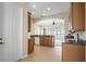 Spacious kitchen features wood cabinets, granite countertops, and a view of the lanai at 2490 Kensington Greens Dr # 0, Sun City Center, FL 33573