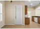 Kitchen with granite counters, wood cabinets, tile flooring, and access to laundry room at 2490 Kensington Greens Dr # 0, Sun City Center, FL 33573