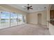 Cozy living room with sliding glass doors and serene water views at 2490 Kensington Greens Dr # 0, Sun City Center, FL 33573