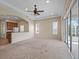 Spacious living room with large windows and a ceiling fan at 2490 Kensington Greens Dr # 0, Sun City Center, FL 33573