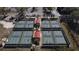 Overhead photo showcasing pickleball courts near mature trees with plenty of room to watch matches at 2490 Kensington Greens Dr # 0, Sun City Center, FL 33573