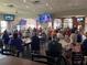 The restaurant is crowded with people dining and watching multiple televisions at 2490 Kensington Greens Dr # 0, Sun City Center, FL 33573