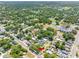 Expansive aerial view showcasing lush green landscape, neighborhood streets, and the home's location amidst mature trees at 302 W Curtis St, Tampa, FL 33603