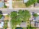 Aerial view of a home surrounded by lush trees in a quiet neighborhood at 302 W Curtis St, Tampa, FL 33603