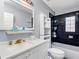 Modern bathroom with sleek black tile, updated fixtures, and a bright, spacious feel at 302 W Curtis St, Tampa, FL 33603