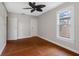 Bedroom with hardwood floors, a ceiling fan, and natural light from the window overlooking the exterior at 302 W Curtis St, Tampa, FL 33603
