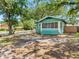 Charming cottage-style home with a screened-in porch and a spacious yard in a residential neighborhood at 302 W Curtis St, Tampa, FL 33603