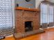 Close-up of a traditional brick fireplace with a wooden mantel and hearth at 302 W Curtis St, Tampa, FL 33603