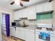 Functional kitchen featuring white cabinetry and essential appliances for everyday cooking at 302 W Curtis St, Tampa, FL 33603