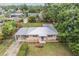 An aerial view of the residence showcasing the metal roof and a covered carport at 3035 Hillview St, Sarasota, FL 34239