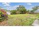 Expansive backyard featuring lush greenery, a wooden fence, and tropical foliage at 3035 Hillview St, Sarasota, FL 34239