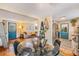 Dining area featuring a round glass table, black chairs, and hardwood floors at 3035 Hillview St, Sarasota, FL 34239