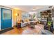 Cozy living room with hardwood floors, bright blue door, and a comfortable couch at 3035 Hillview St, Sarasota, FL 34239