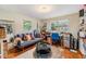 Cozy living room with hardwood floors, a comfortable sofa, and a bright workspace near the window at 3035 Hillview St, Sarasota, FL 34239