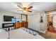 Comfortable main bedroom with a ceiling fan, a decorative fireplace, a TV, and large closet at 3035 Hillview St, Sarasota, FL 34239