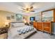 Spacious main bedroom with a ceiling fan, a decorative fireplace, a TV, and large dresser at 3035 Hillview St, Sarasota, FL 34239