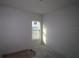 Bright bedroom features a large window and fresh white paint ready for personalization at 316 Vistera Blvd, Nokomis, FL 34275