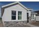 New home exterior showing siding, stonework and double hung windows at 316 Vistera Blvd, Nokomis, FL 34275