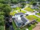 Beautiful aerial view of a house with a screened-in pool and boat house on a freshwater canal at 3724 Fawn Grove Ct, Land O Lakes, FL 34639