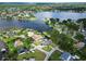 Captivating aerial view of lakeside community with homes surrounded by trees and serene lake waters at 3724 Fawn Grove Ct, Land O Lakes, FL 34639