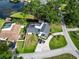 Beautiful aerial view of a home featuring a pool, lush landscaping, and lake access at 3724 Fawn Grove Ct, Land O Lakes, FL 34639