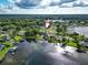 An aerial view of a waterfront house on a lake at 3724 Fawn Grove Ct, Land O Lakes, FL 34639