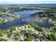Aerial view showcases the lakefront property with lush surroundings and stunning waterfront at 3724 Fawn Grove Ct, Land O Lakes, FL 34639