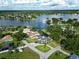 Wide aerial view of a community with lakefront property at 3724 Fawn Grove Ct, Land O Lakes, FL 34639