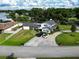 Expansive aerial view of a home with spacious yard, circular drive, and partial lake view at 3724 Fawn Grove Ct, Land O Lakes, FL 34639