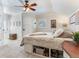 Comfortable bedroom featuring built-in under-bed storage, neutral carpeting, and an abundance of natural light from a window at 3724 Fawn Grove Ct, Land O Lakes, FL 34639