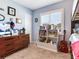 Well-organized bedroom with a bookshelf, chest of drawers, and neutral walls at 3724 Fawn Grove Ct, Land O Lakes, FL 34639