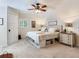 Inviting bedroom with built-in storage under the bed, complemented by a ceiling fan and natural light from the window at 3724 Fawn Grove Ct, Land O Lakes, FL 34639