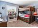 bedroom with bunkbeds, a bookcase, and a desk for study, complete with neutral walls at 3724 Fawn Grove Ct, Land O Lakes, FL 34639