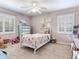 Cozy bedroom offers a plush bed with floral bedding and an abundance of natural light at 3724 Fawn Grove Ct, Land O Lakes, FL 34639